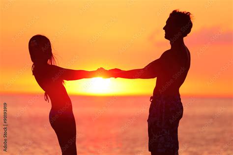 Silhouette Couple Holding Hands At Beach Loving Partners Are Spending