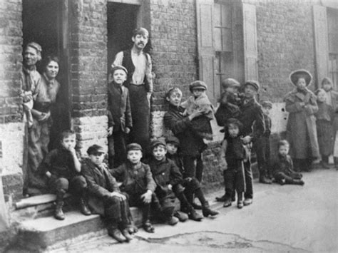 A Group Of Boys And Their Families Living In The East End Of London In