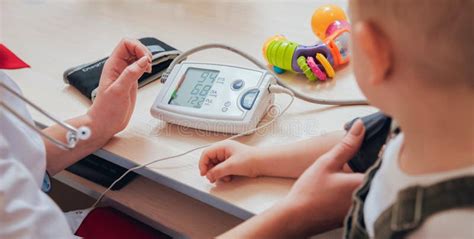 Doctor Measuring Blood Pressure Of A Child Stock Photo Image Of