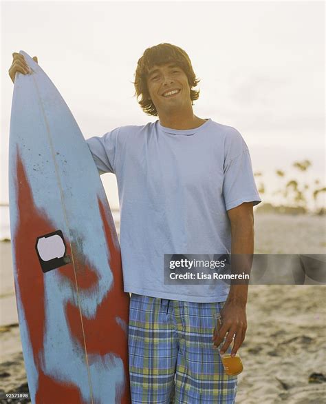 Smiling Man With Surfboard High Res Stock Photo Getty Images