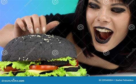 Hungry Woman Eating A Big Burger At A Party Stock Footage Video Of Woman Portrait 229345004