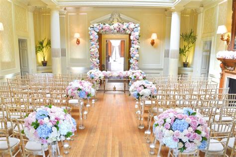 Dusty blue accented with some blush is so romantic that is popularly used in spring weddings. Dusty blue and pink wedding flowers and cake at Hedsor ...