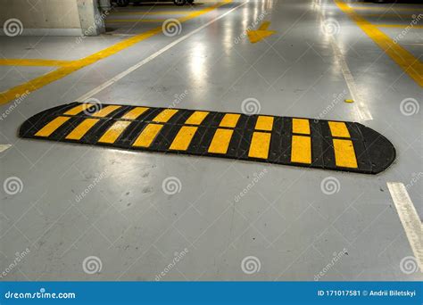 Striped Black And Yellow Speed Bump On A Road Stock Image Image Of