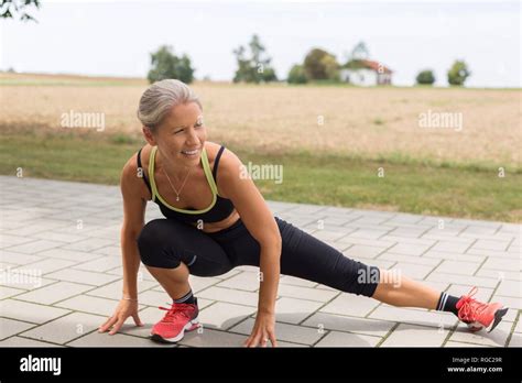 Mature Woman Doing Workout In The Countryside In Summer Stock Photo Alamy