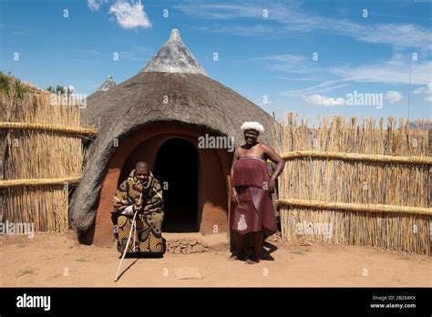 Basotho Man And Woman In Front Of Traditional Hut Thaba Bosiu Cultural Village Lesotho Stock