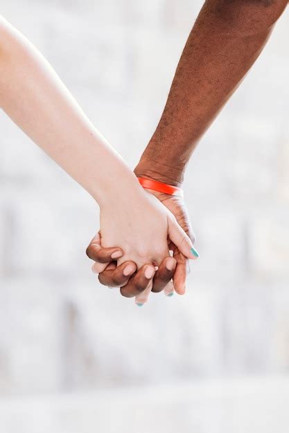 Close Up Of Interracial Couple Holding Hands Photo Free Download