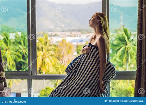 Young Happy Woman Woke Up In The Morning In The Bedroom By The Window