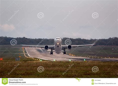 Airplane Moments After Takeoff Leaving Runway Behind Stock Image