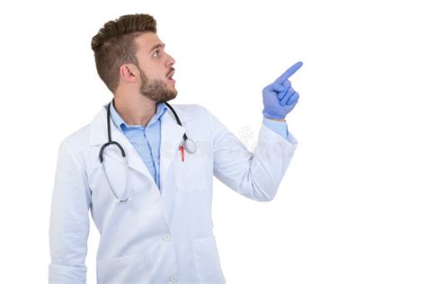 Portrait Of A Smiling Male Doctor Pointing Finger Away Isolated On A