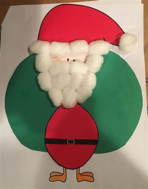 A Paper Plate With A Santa Clause On It And A Green Circle Around The Face