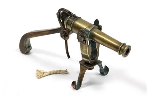 An Antique Brass Naval Ships Swivel Mounted Desk Cannon With Trigger