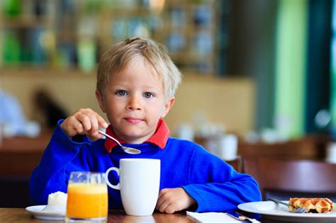Little Boy Eating Breakfast In Cafe Stock Photo Download Image Now