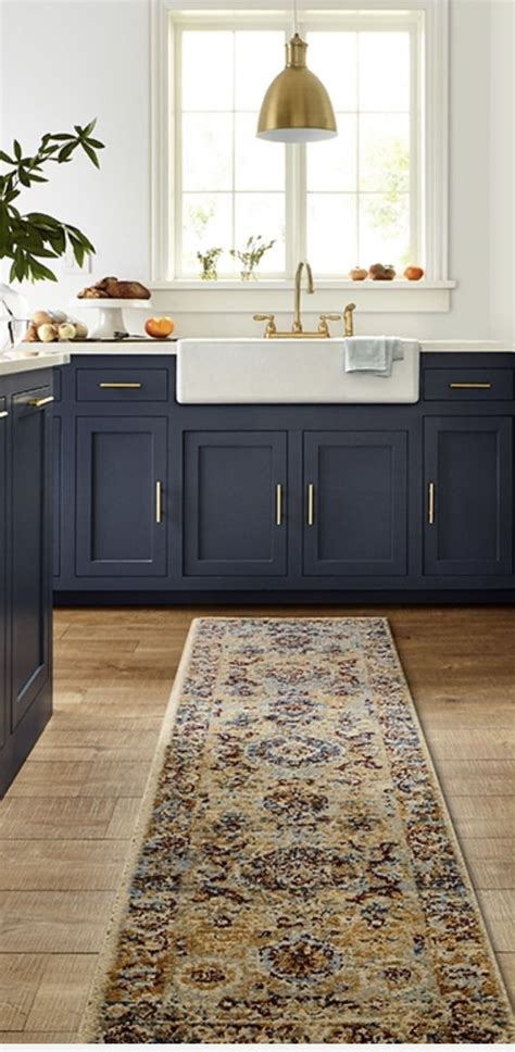 Painting your kitchen cabinets white is a smart design move that will likely keep you satisfied for years to come. Love the navy cabinets and white farmhouse sink with light ...