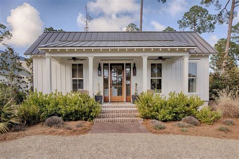 Charming White Coastal Cottage With Board And Batten Exterior And
