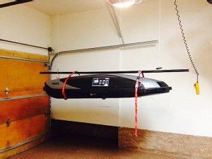 Suspended shelving might just be for you if you're planning to make use of every square foot of your garage. garage storage solutions - overhead thule pulley rack | Diy overhead garage storage, Kayak ...