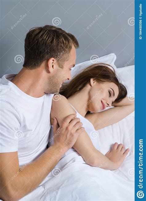 Young Happy Couple On The Bed Stock Photo - Image of beautiful, bedroom: 184450356