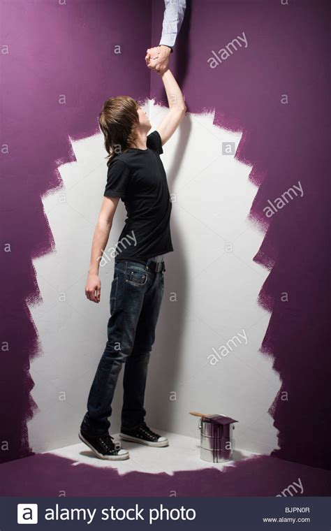 Teenage Boy Climbing A Ladder Stock Photo Alamy