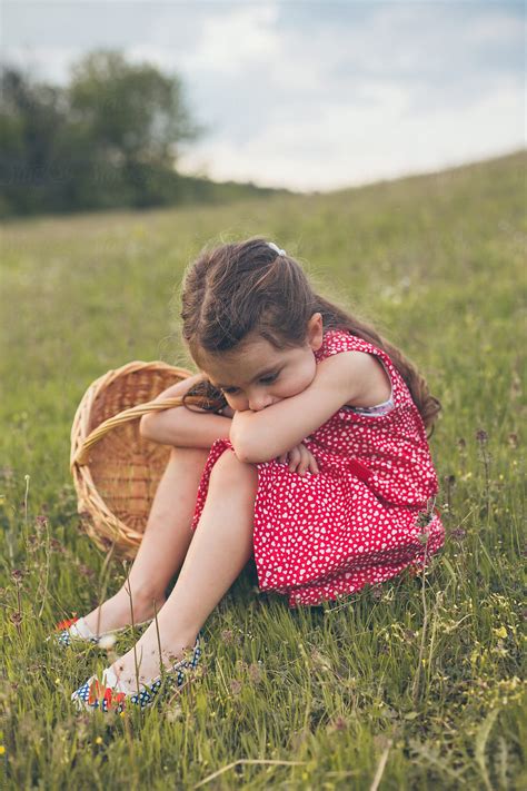 Sad Little Girl Sitting In Grass By Dejan Ristovski