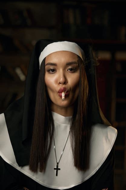 Premium Photo Portrait Of Naughty Sexy Nun Wearing Robe And Headdress Smoking Cigarette