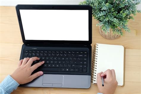 Premium Photo Hand Typing Laptop With Blank Screen And Writing On