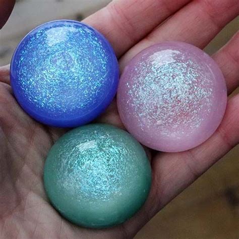 Three Different Colored Balls In The Palm Of Someone S Hand One Blue