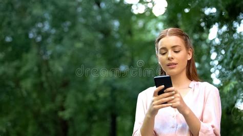 Beautiful Young Girl Chatting On Smartphone Spending Time Outdoor