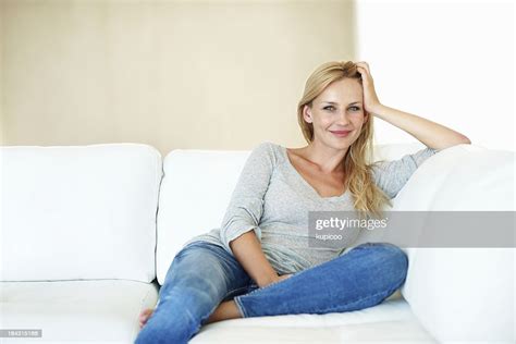 Smiling Middle Aged Woman On Couch Stock Photo Getty Images