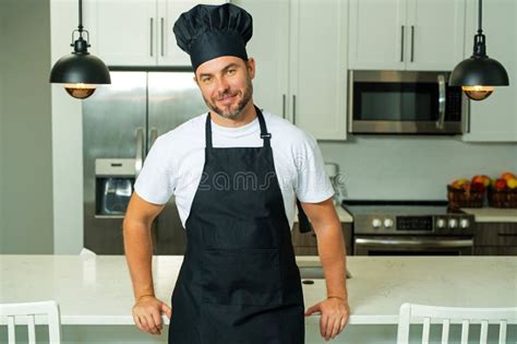 Portrait Of Chef Man In A Chef Cap In The Kitchen Man Wearing Apron And Chefs Uniform And Chefs