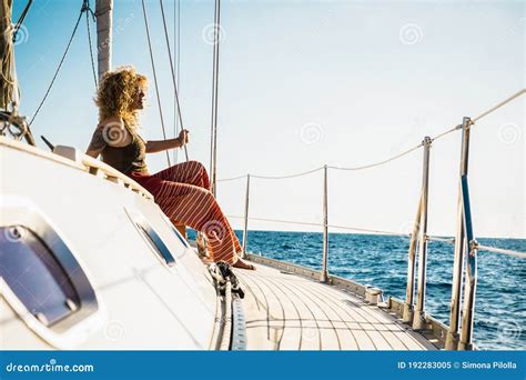 Young Beautiful Girl Lay Down And Relax On A Sail Boat Enjoying Silence