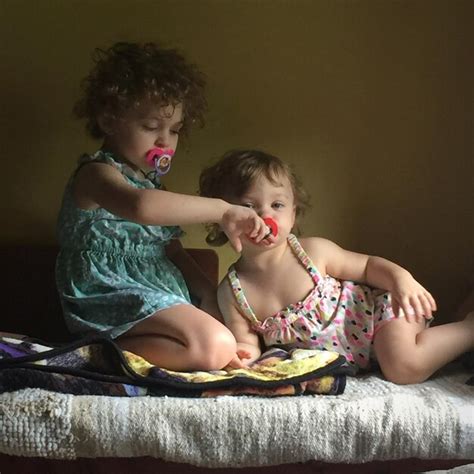 Premium Photo Sisters Sucking Pacifiers At Home