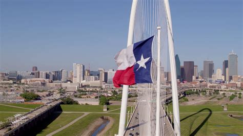 Dallas Skyline, Margaret Hunt Hill Bridge, State Flag Stock Video ...