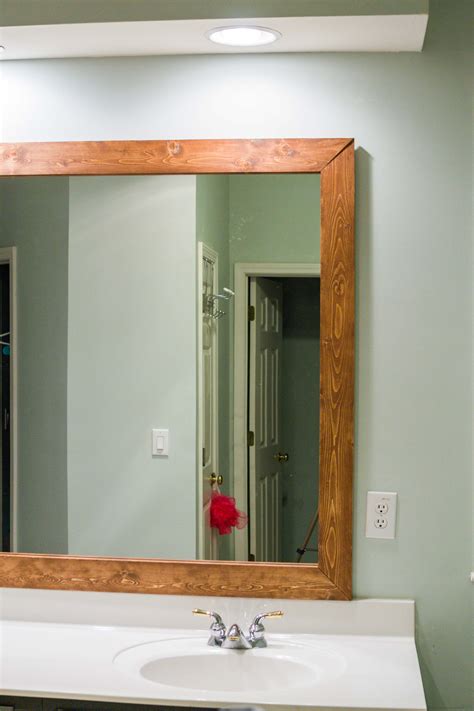 How To Diy Upgrade Your Bathroom Mirror With A Stained Wood Frame Building Our Rez Bathroom