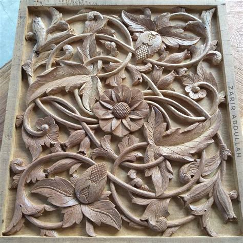 An Intricately Carved Wooden Panel With Flowers And Leaves