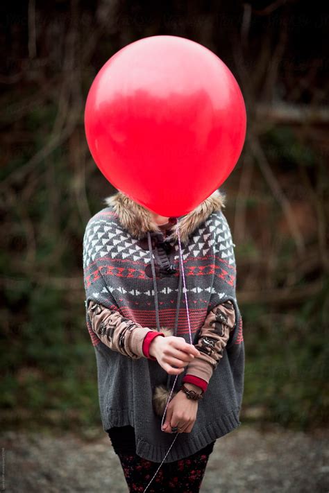 Woman Hiding Face Behind Balloon Del Colaborador De Stocksy Laura