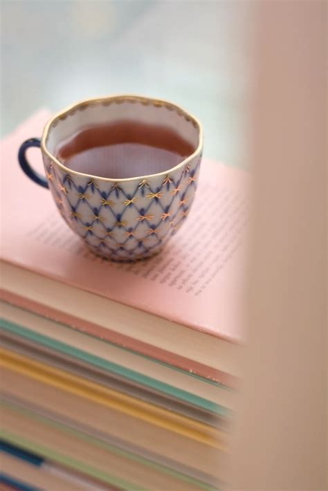 Tea Tea In A Vintage Porcelain Cup On A Pile Of Old Books Near The