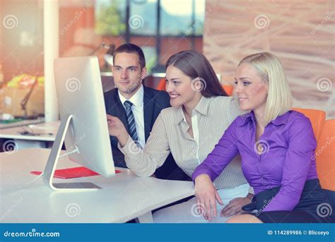 Group Of Colleagues Working Together In An Office Stock Photo Image
