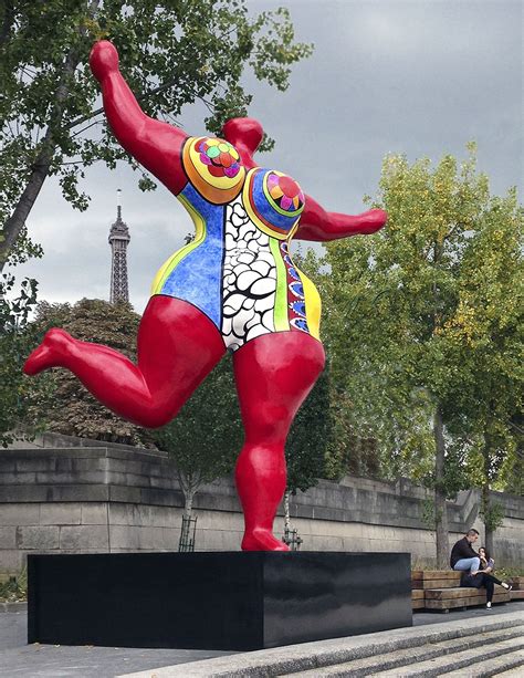 A Red Nana Scupture By Niki De Saint Phalle On The Walk Way By The