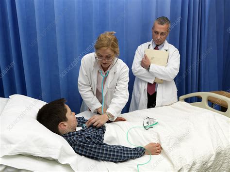 Doctor Examining Patient In Hospital Stock Image F0057534