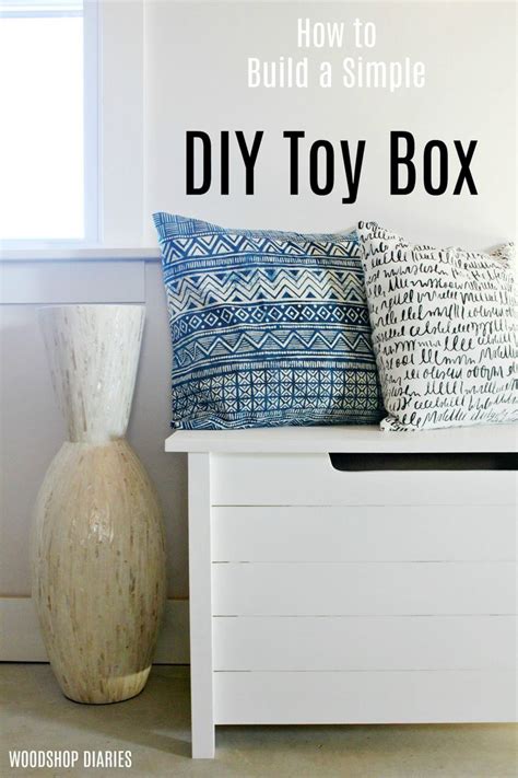 The Diy Toy Box Is Sitting Next To A Vase And Pillow On A Bench