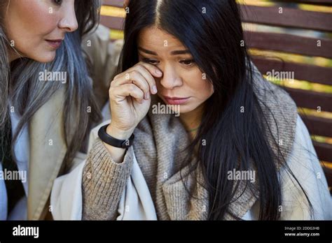 Caring Woman Comforting Crying Friend On The Street Stock Photo Alamy