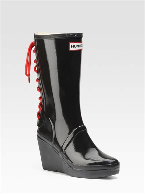 hunter glossy rubber wedge rain boots in black lyst