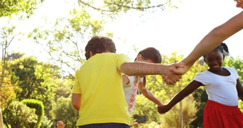Children Playing Ring Around The Rosy In Park Stock Footage Video Of