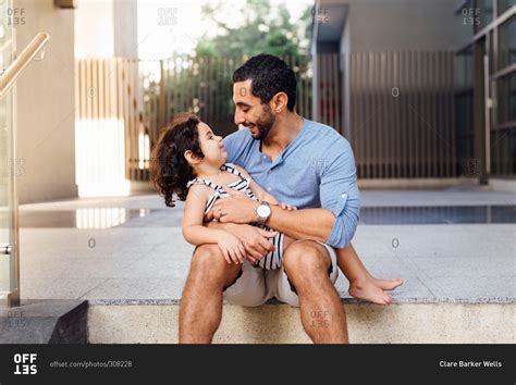 Loving Father Holding Girl In Lap Stock Photo OFFSET