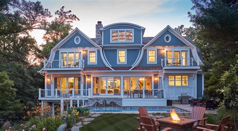 Gambrel roofs, swooping capped oval windows, and a curved dormer