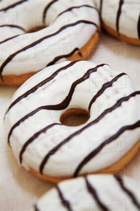 Iced Donuts With Chocolate Stripes Stock Photo Dissolve