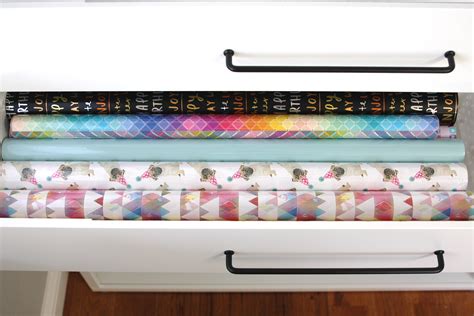 Cute patterned boxes keep things organized and are pretty enough to be displayed on a dresser. Organized Gift Wrap Shelf & Drawers - simply organized