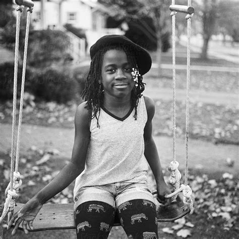 View Stylish Black Girl With Berret On A Swing By Stocksy Contributor