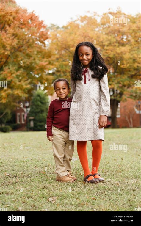 African American Brother And Sister Smiling In Park Stock Photo Alamy