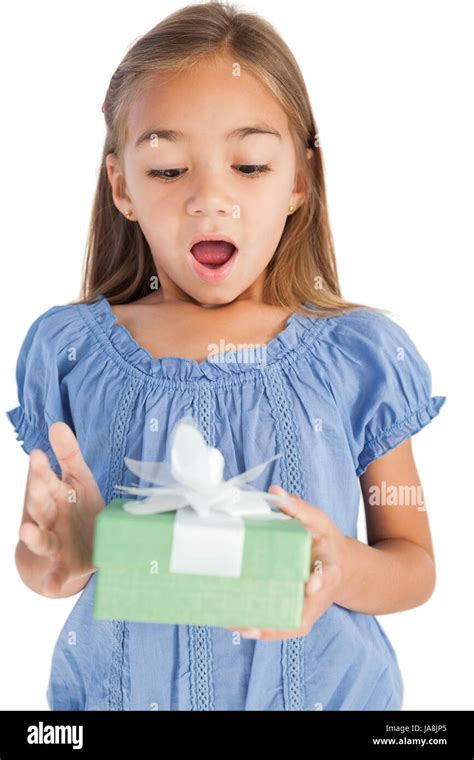 Surprised Little Girl Holding A Wrapped T On White Background Stock