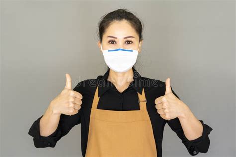 Asian Woman Housewife In Brown Apron Wore Face Mask Isolated On Gray Backgroundhousework And
